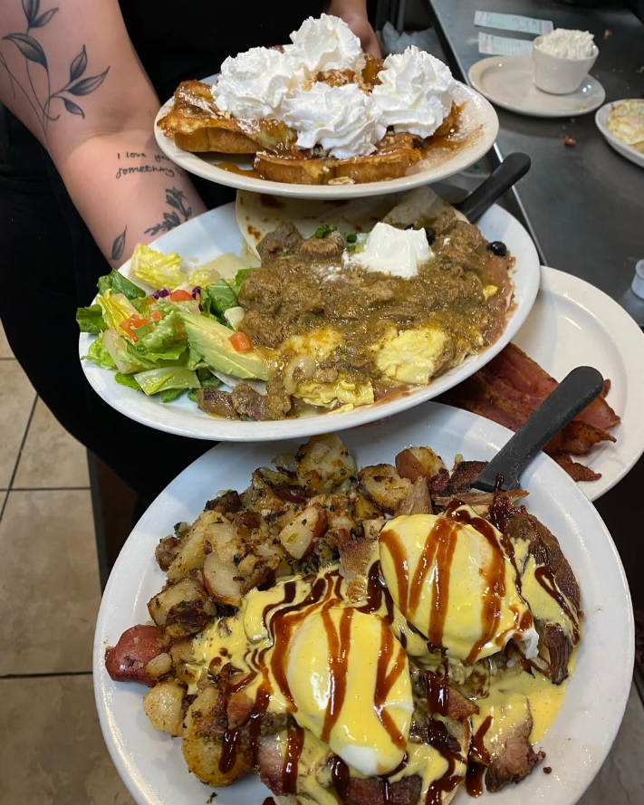 Stacked pancakes and breakfast plates
